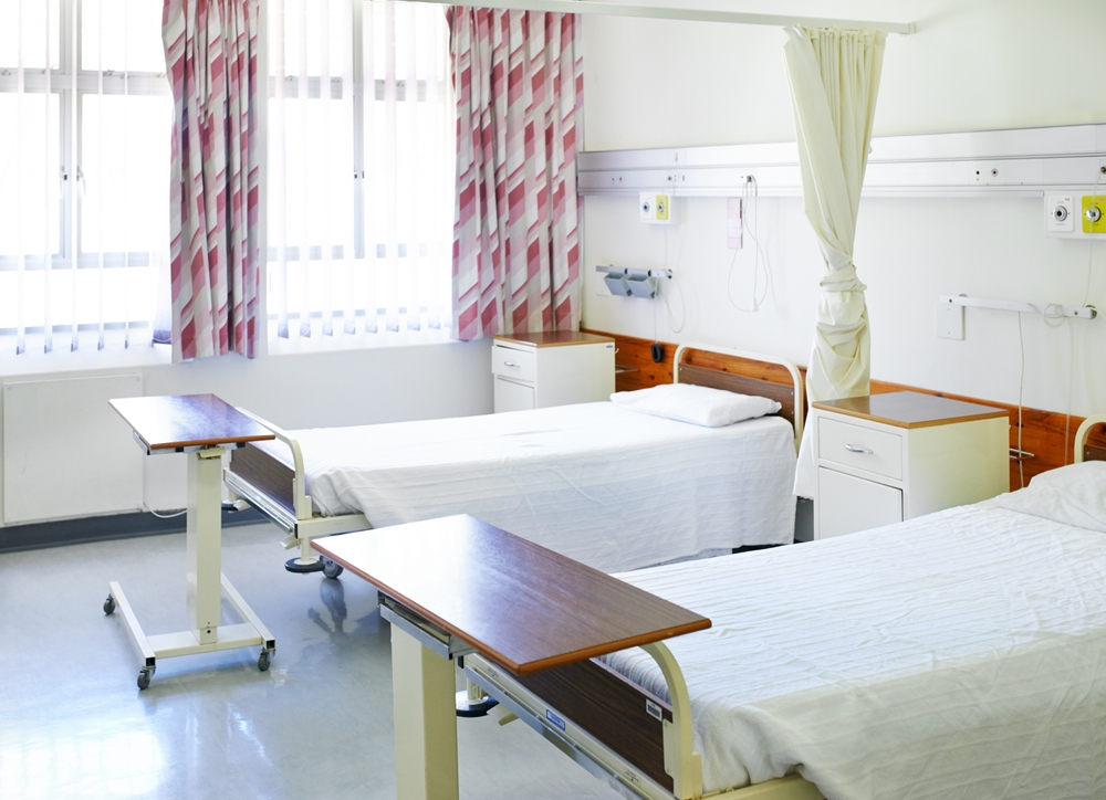 Empty beds in a nursing home room, illustrating the long-term care bed shortage